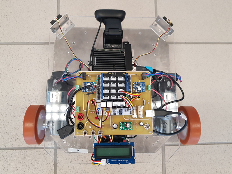 Top view of the mobile robot showing the electronics, motors, wiring and sensor arrangement
