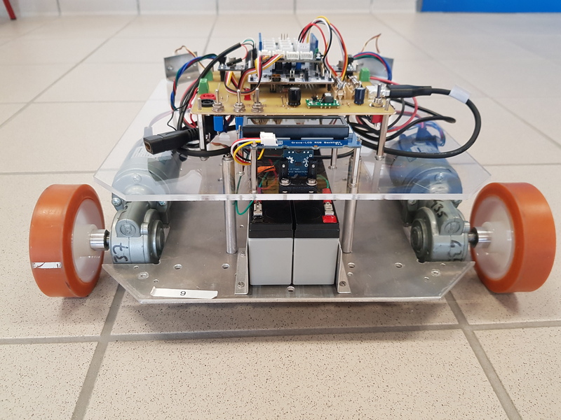 Rear view of the mobile robot showing its mechanical frame, drive motors and onboard electronics